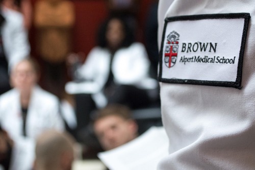 close-up of a white coat with a Brown medical school logo